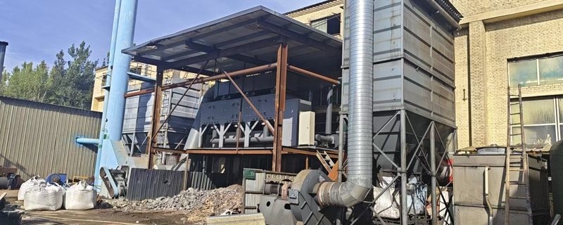 Dust collection and off-gas treatment equipment in the plant yard — the equipment the approval requires for the added capacity.